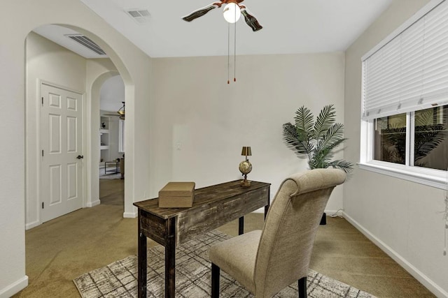 carpeted home office with ceiling fan