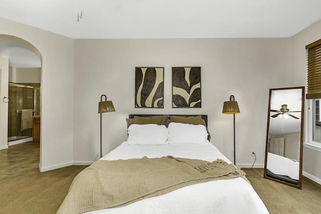 bedroom featuring ensuite bathroom and carpet floors