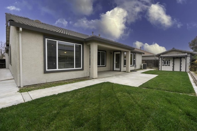 back of house with a patio area, a lawn, a storage shed, and central air condition unit