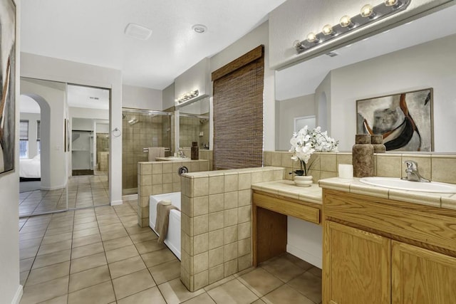 bathroom with plus walk in shower, tile patterned floors, and vanity