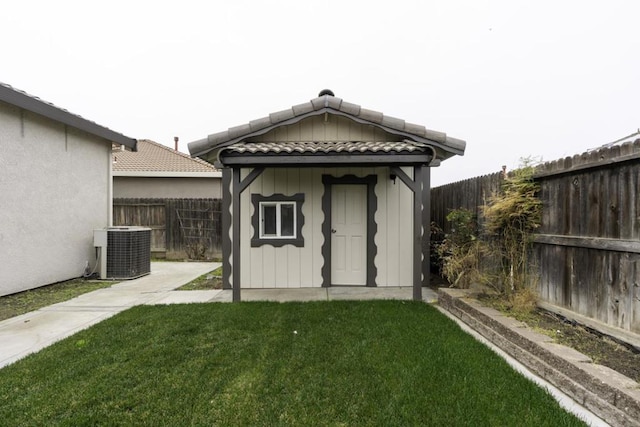 view of outbuilding with central AC and a yard