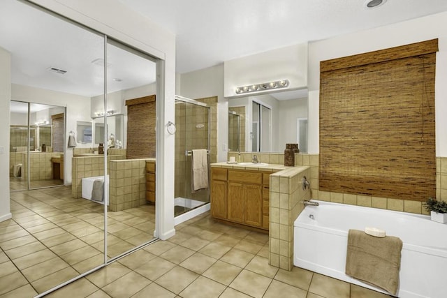 bathroom featuring tile patterned floors, vanity, and separate shower and tub