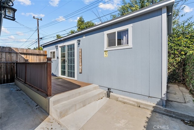 view of side of home with a deck and a patio area