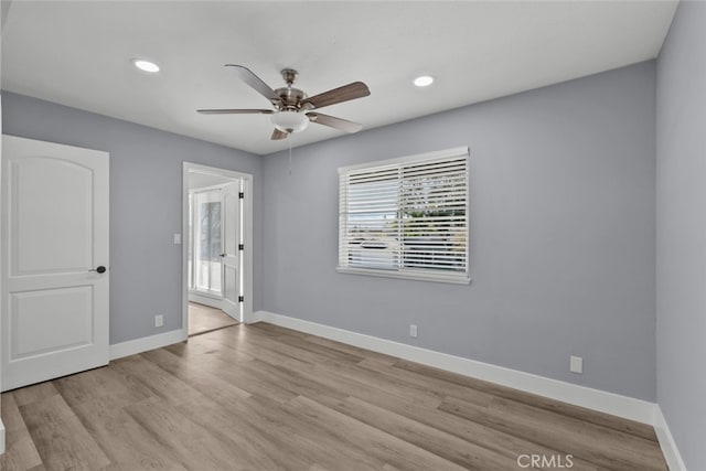 unfurnished room with ceiling fan and light wood-type flooring