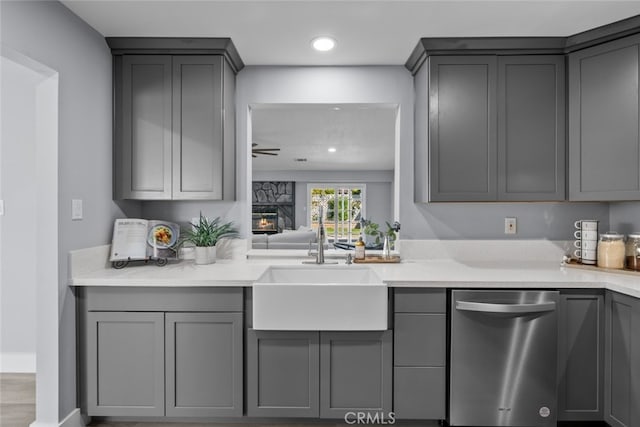 kitchen with dishwasher, sink, and gray cabinetry