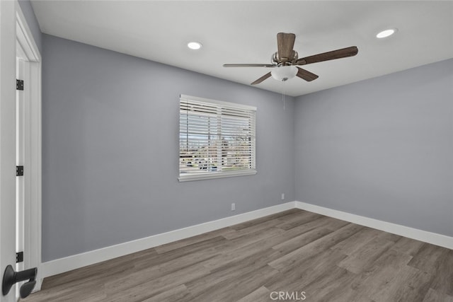 spare room with ceiling fan and light hardwood / wood-style floors