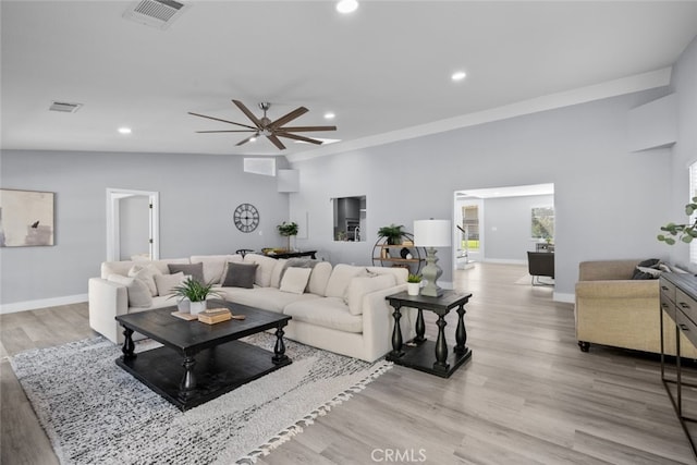 living room with light hardwood / wood-style flooring and ceiling fan