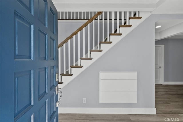 entryway with dark hardwood / wood-style flooring