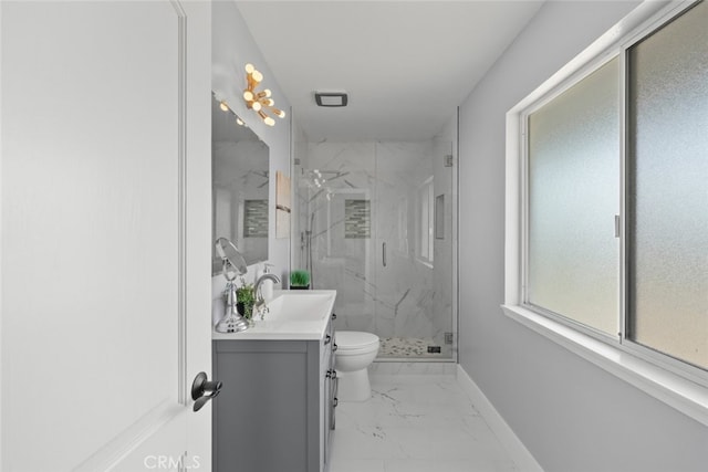 bathroom featuring vanity, toilet, and a shower with shower door