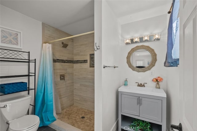 bathroom with toilet, vanity, and a shower with shower curtain