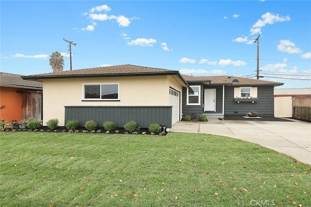 ranch-style house featuring a garage and a front yard