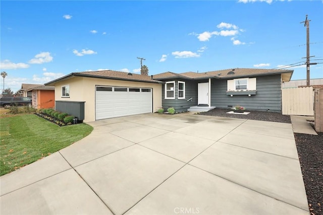 ranch-style house featuring a front lawn and a garage