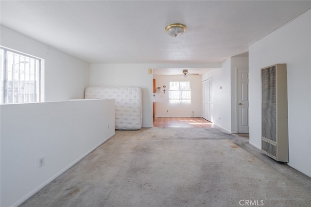 empty room featuring light carpet and ceiling fan