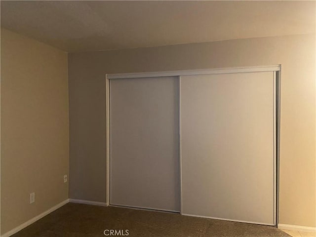 unfurnished bedroom featuring carpet floors and a closet