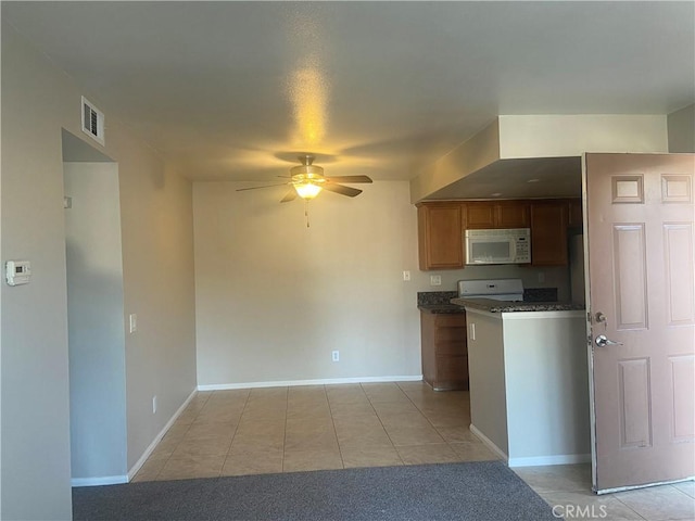 kitchen with ceiling fan, light tile patterned floors, and white appliances