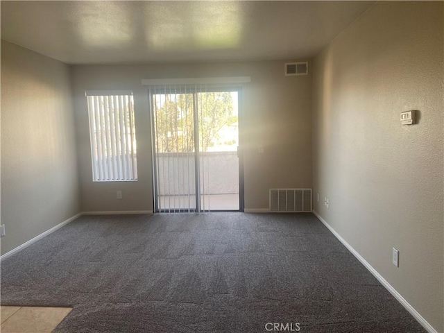 unfurnished room with carpet floors