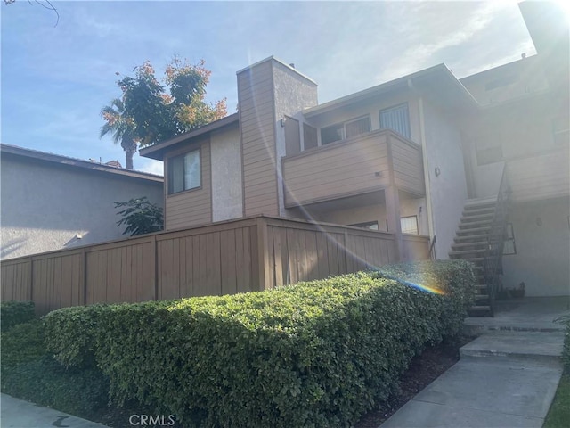 view of side of home featuring a balcony