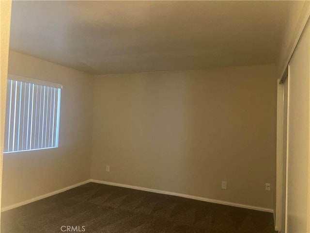 empty room featuring dark carpet