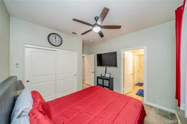 bedroom featuring ceiling fan, a closet, and light carpet