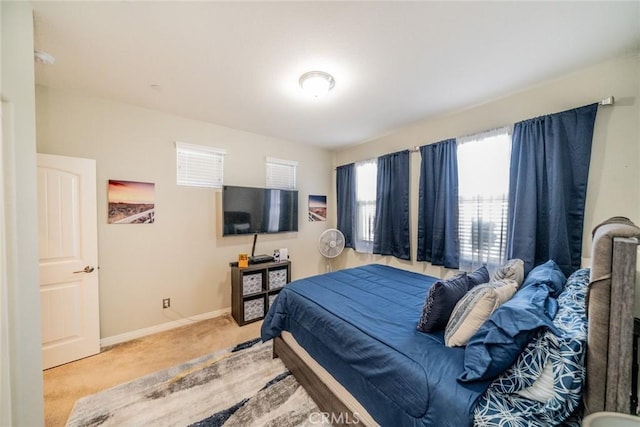 bedroom featuring light carpet