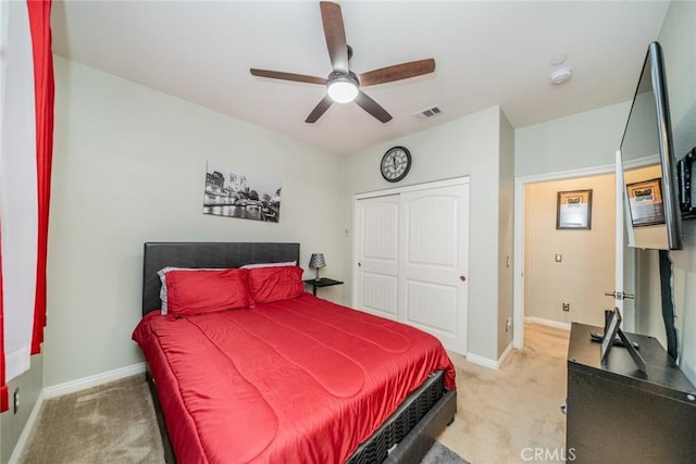 bedroom with ceiling fan, carpet, and a closet