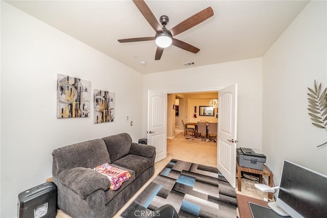 carpeted living room with ceiling fan