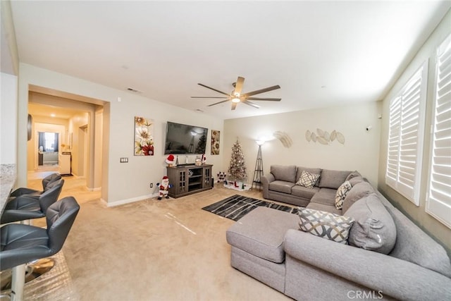 living room with ceiling fan and carpet floors