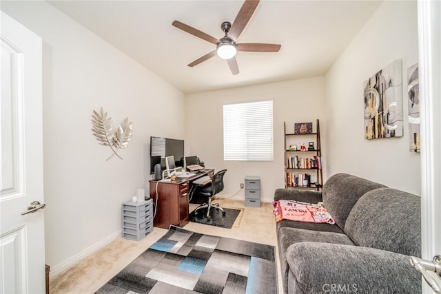 home office featuring light carpet and ceiling fan