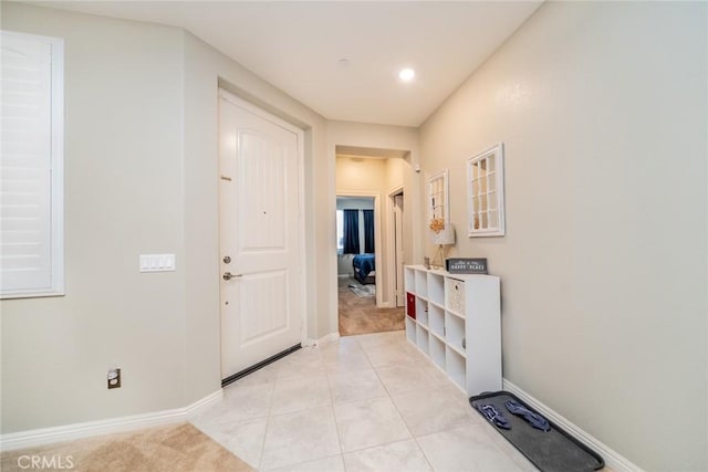 foyer entrance with light tile patterned floors