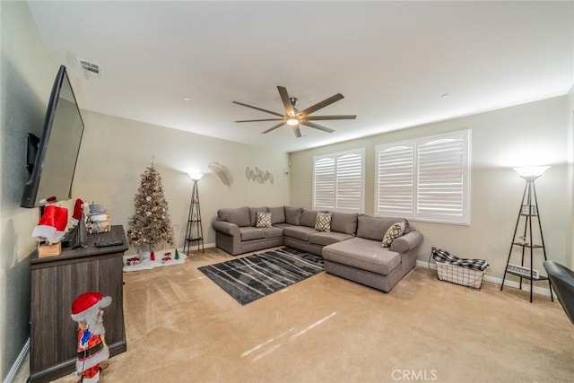 carpeted living room featuring ceiling fan