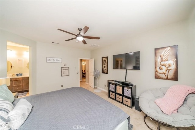 carpeted bedroom with ceiling fan and ensuite bath