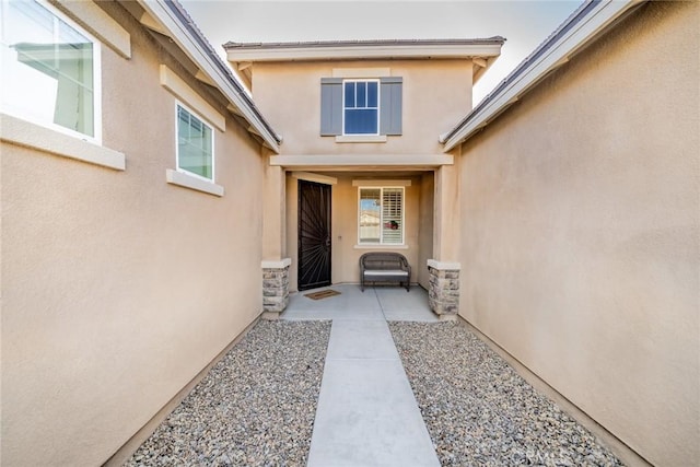 view of exterior entry featuring a patio