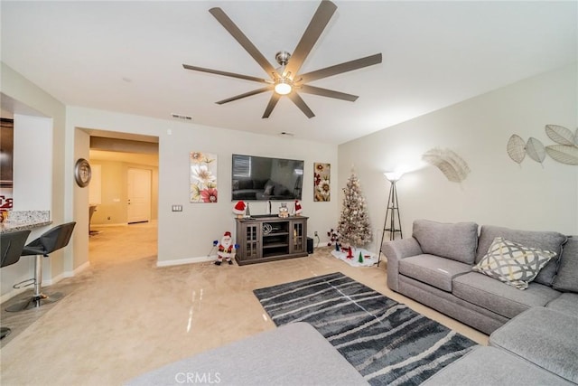 living room featuring ceiling fan and carpet