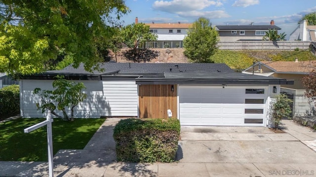 single story home featuring a front yard and a garage