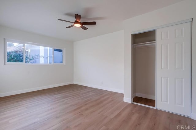 unfurnished bedroom with ceiling fan, a closet, and light hardwood / wood-style floors