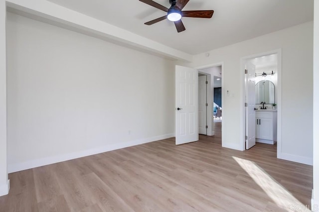 unfurnished bedroom featuring ceiling fan, connected bathroom, and light hardwood / wood-style flooring