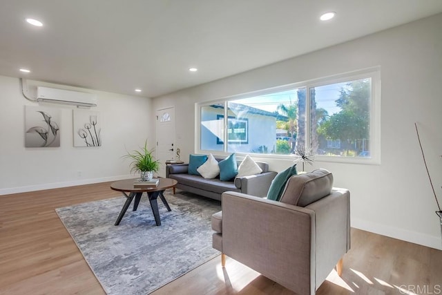 living room with a wall mounted AC and light wood-type flooring