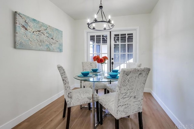 dining space with a chandelier and hardwood / wood-style flooring