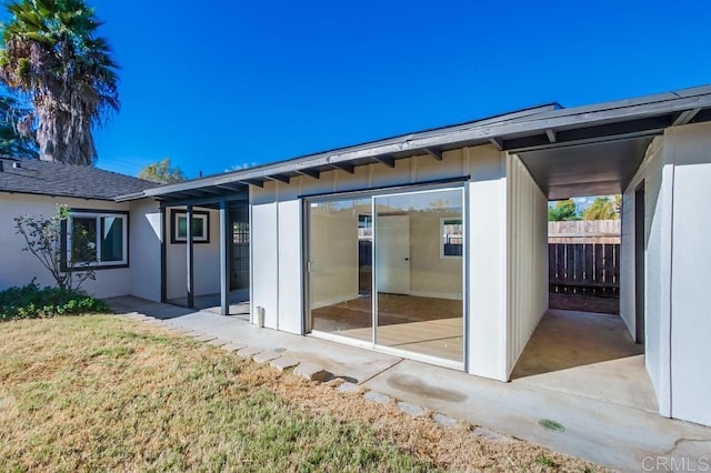 rear view of property with a yard and a patio