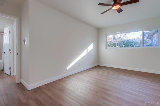 empty room with ceiling fan and light wood-type flooring