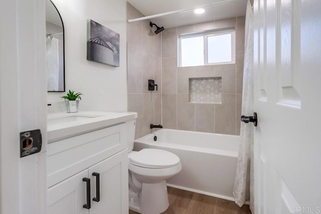 full bathroom with toilet, wood-type flooring, vanity, and shower / bath combo with shower curtain