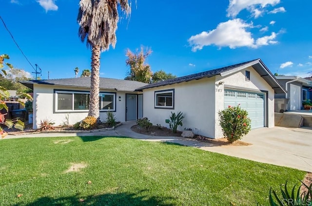 ranch-style house featuring a front lawn and a garage