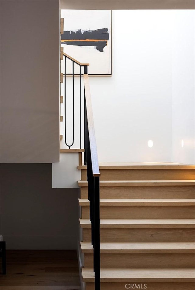 stairs featuring hardwood / wood-style floors