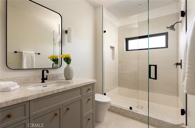 bathroom with toilet, vanity, tile patterned floors, and a shower with door