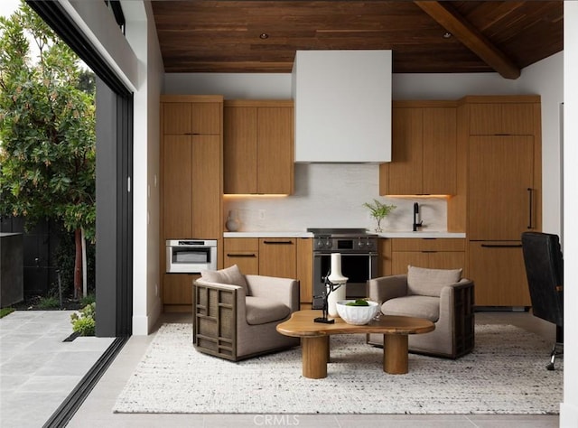 kitchen with vaulted ceiling with beams, backsplash, appliances with stainless steel finishes, and wooden ceiling