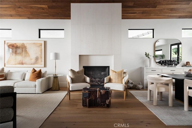 sitting room with dark wood-type flooring, wooden ceiling, and lofted ceiling