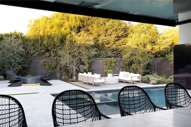 view of patio / terrace featuring a fenced in pool and an outdoor hangout area