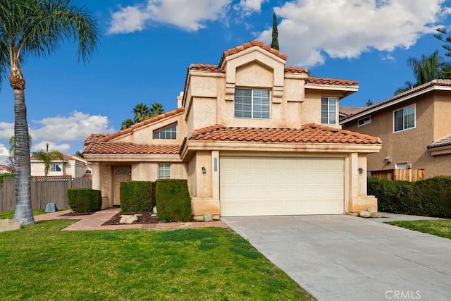 mediterranean / spanish-style house featuring a front lawn and a garage