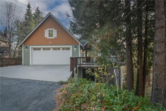 view of front facade featuring a garage and an outbuilding