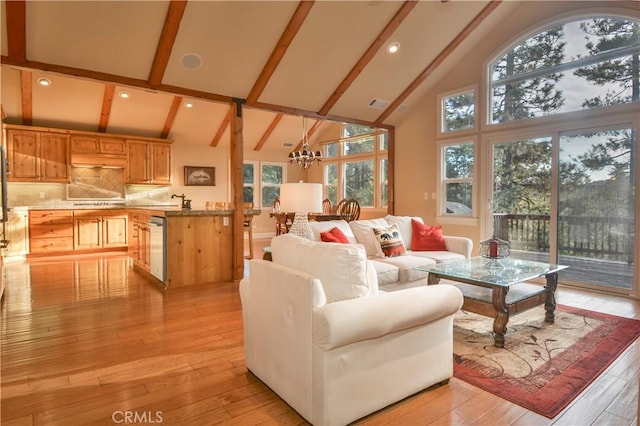 173 Grizzly Rd, Lake Arrowhead, CA 92352 - living area with high vaulted ceiling, a chandelier, beamed ceiling, light wood-type flooring, and healthy amount of natural light